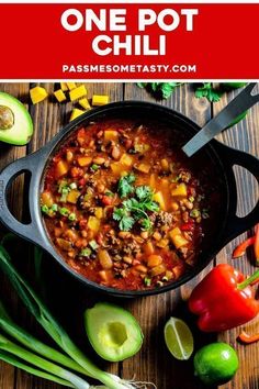 one pot chili in a black skillet with avocado and cilantro on the side