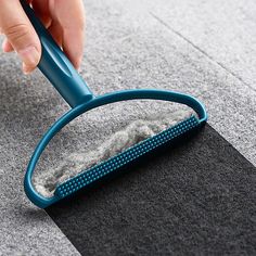 a person using a brush to clean carpet