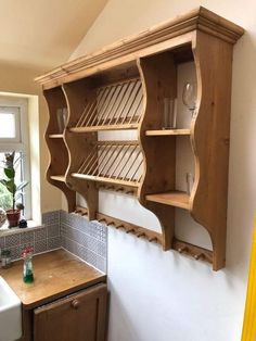 a wooden shelf sitting above a sink in a kitchen