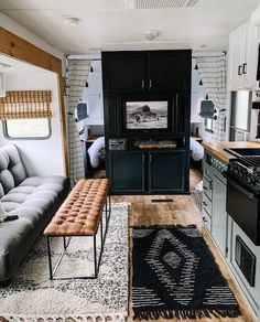 a living area with couch, kitchen and stove