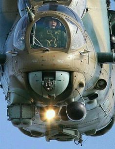 an air force plane with its lights on and the pilot in the cockpit looking out