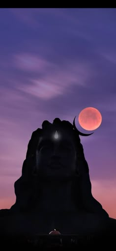 the moon is setting behind a statue with its head turned to look like a human face