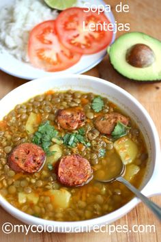 two bowls filled with soup next to rice and avocado slices on the side