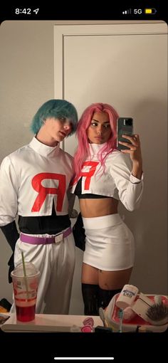 two people dressed up in costumes taking a selfie with a cell phone while standing next to each other