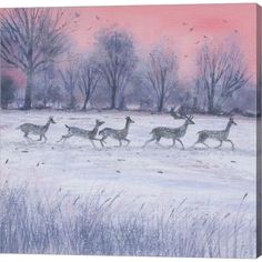 a group of deer running across a snow covered field in front of trees and pink sky