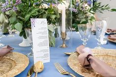 a table set with place settings and flowers