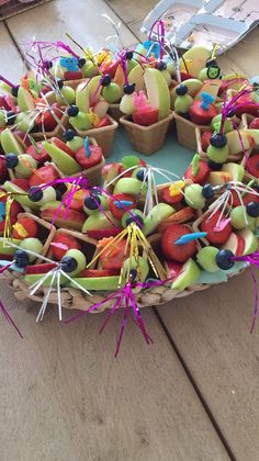 a wreath made out of fruit and sticks on top of a wooden table with other items