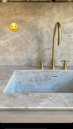 a bathroom sink sitting under a mirror next to a faucet and counter top