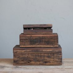 three wooden boxes stacked on top of each other