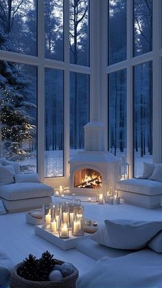 a living room filled with lots of white furniture next to a window covered in snow