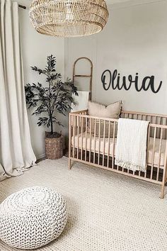 a baby's room with a wicker crib and white rug