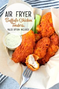 a basket filled with fried food next to a fork