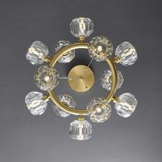 a golden chandelier with clear glass balls on it's center and sides