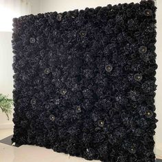 a large black piece of art that looks like it has been made out of flowers