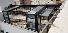 the roof of a building that is under construction with scaffolding on it and several windows