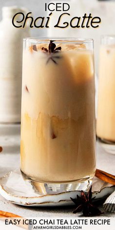 an iced chai latte in a glass on a plate