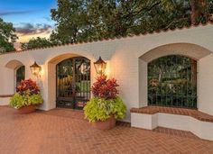 a white house with two large planters on the front