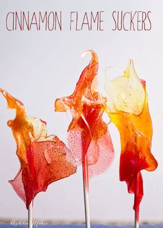 three candy lollipops with the words cinnamon flame suckerrs above them on a white background