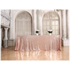 a table covered in pink sequins and vases with flowers sitting on it