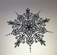 a black and white drawing of a snowflake on the side of a wall