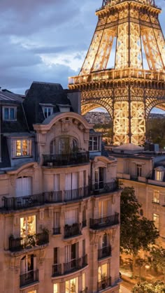 the eiffel tower is lit up at night