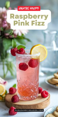 raspberry pink fizz cocktail with lemon and mint garnish on the rim