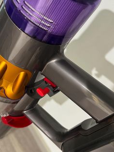 a close up view of a purple and yellow vacuum