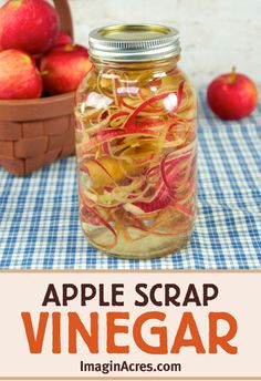 an apple scrap is in a jar next to some apples