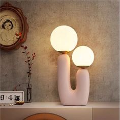 two white lamps sitting on top of a table