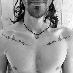 a man with long hair and tattoos on his chest is wearing a necklace that says heartbeat