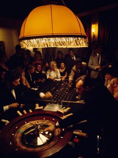 a group of people playing roulege in a dark room