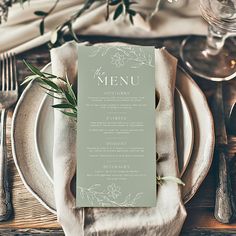 an elegant table setting with silverware, napkins and place settings for the menu