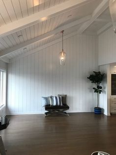 a living room with wood floors and white walls