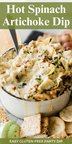 an artichoke dip in a bowl with crackers on the side