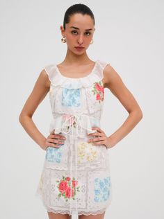 Inspired by the table linens you'd find at Nonna's house in the Italian countrysidethe Aviana ivory mini dress is brimming with laid-back summer charm. Featuring contrast ruffles at the waist and neckline, this short sundress spotlights multiple printed patchworks surrounded by nostalgic Battenburg lace detailing. Ivory Mini Dress, Short Sundress, Battenburg Lace, Italian Countryside, Mini Dress White, Little White Dresses, Floral Mini Dress, White Mini Dress, Dress White