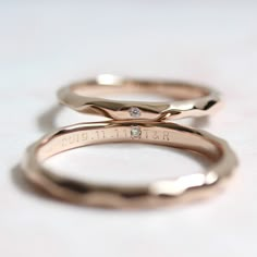 three gold wedding rings with diamonds on them