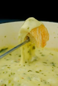 a ladle full of broccoli and cheese soup