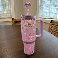 a purple cup sitting on top of a wooden table