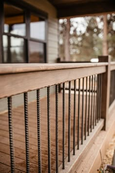 a wooden porch with metal railings on it