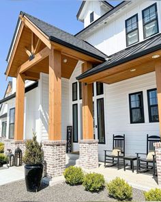 a white house with wood trim and black shutters