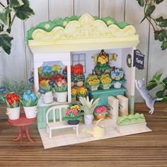 a miniature model of a flower shop with potted plants