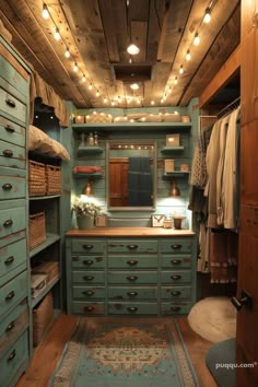 a closet with lots of drawers and lights on the ceiling is shown in this image