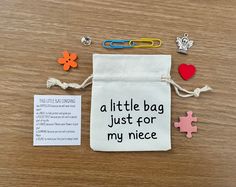 a little bag just for my niece has been placed on the table with paper clips and magnets