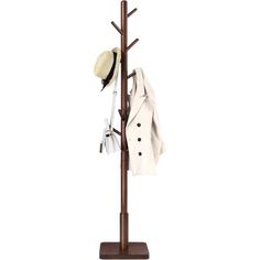 a coat rack with two hats on it and clothes hanging from the top, in front of a white background