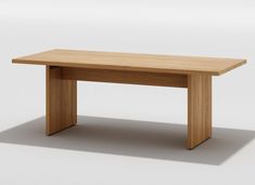 a wooden table sitting on top of a white floor