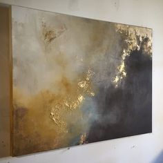 a painting is hanging on the wall in an empty room