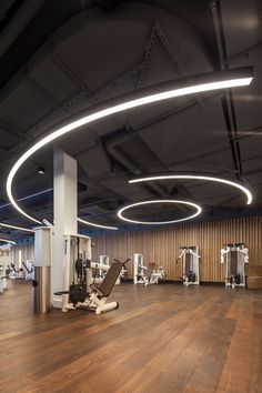 an empty gym with many machines and equipment