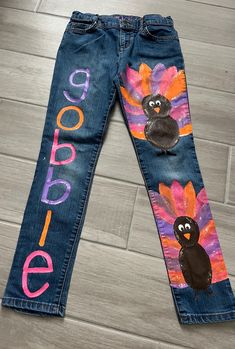 a pair of jeans with turkeys painted on the side and words goodbye written in large letters