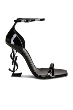 Find SAINT LAURENT Opyum 110 Ysl Heeled Sandals In Black on Editorialist. Saint Laurent Opyum 110 YSL Heeled Sandals in Black Patent leather lambskin upper with leather sole. Made in Italy. Ankle strap with buckle closure. Metal YSL initial sculptural heel. Open square toe. Approx 110mm/ 4.3 inch heel. SLAU-WZ964. 557662-0NPVV-1000. About the designer: SAINT LAURENT has been influencing and revolutionizing the fashion industry since the debut of its iconic ‘Rive Gauche’ collection in 1966 - the couture house was the first to create a ready-to-wear capsule. The sleek, precisely tailored staples, like the signature biker jackets, transcend seasons and trends. Creative Director Anthony Vaccarello continues to honor the label’s illustrious reputation by reintroducing cult styles, including the School Baddie, Ysl Handbags, Baby Wardrobe, Heels Aesthetic, Ysl Heels, Crystal Sandals, Biker Jackets, Rive Gauche, Black Sandals Heels