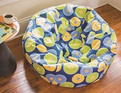 a bean bag chair sitting on top of a wooden floor next to a coffee table